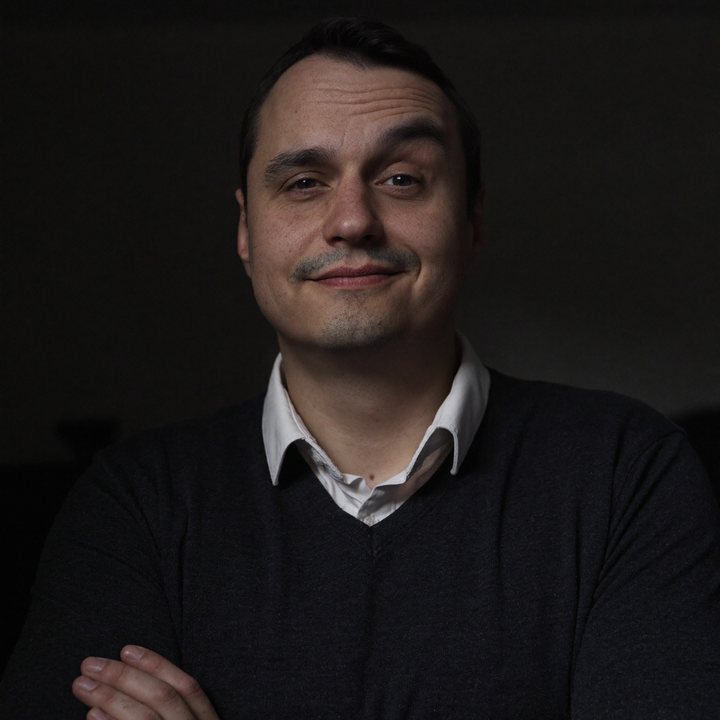 Jev Ivanov, arms crossed, smiling